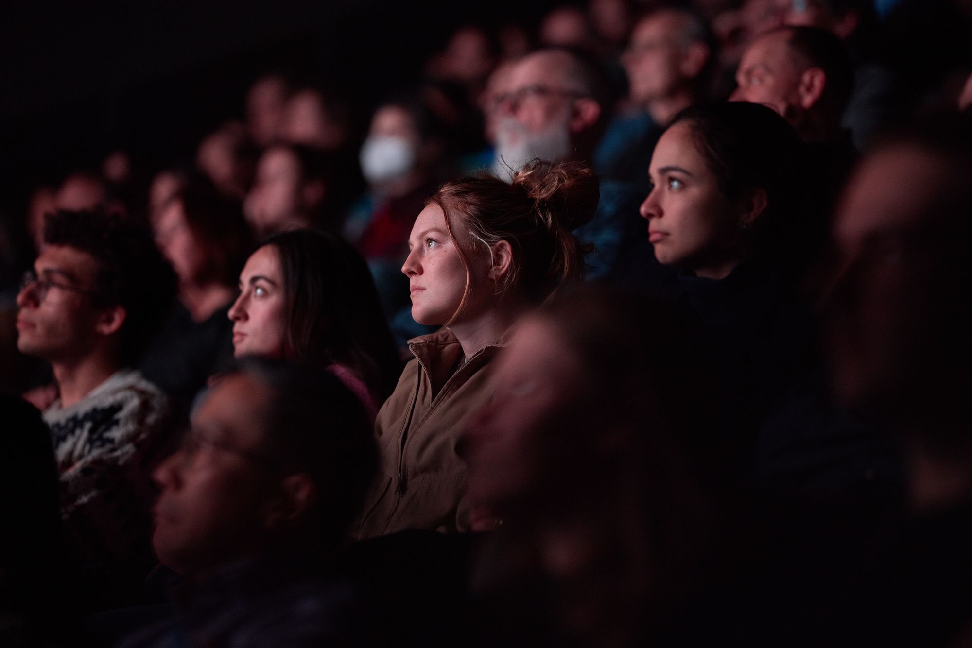A close-up of a thoughtful viewer in the audience.